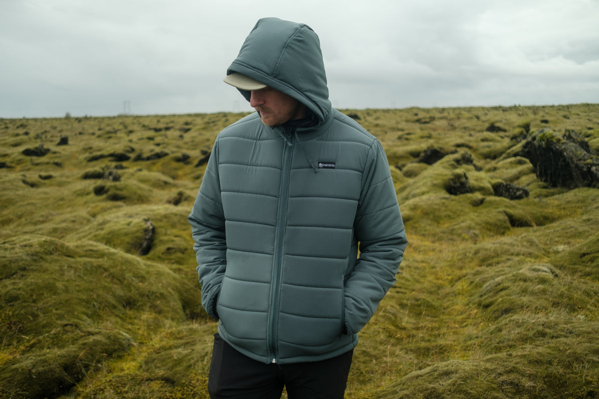 Fortress Clothing insulated jacket in a snowy mountain landscape